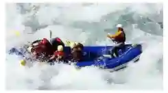 Group enjoying white water rafting through scenic river valleys in Nepal